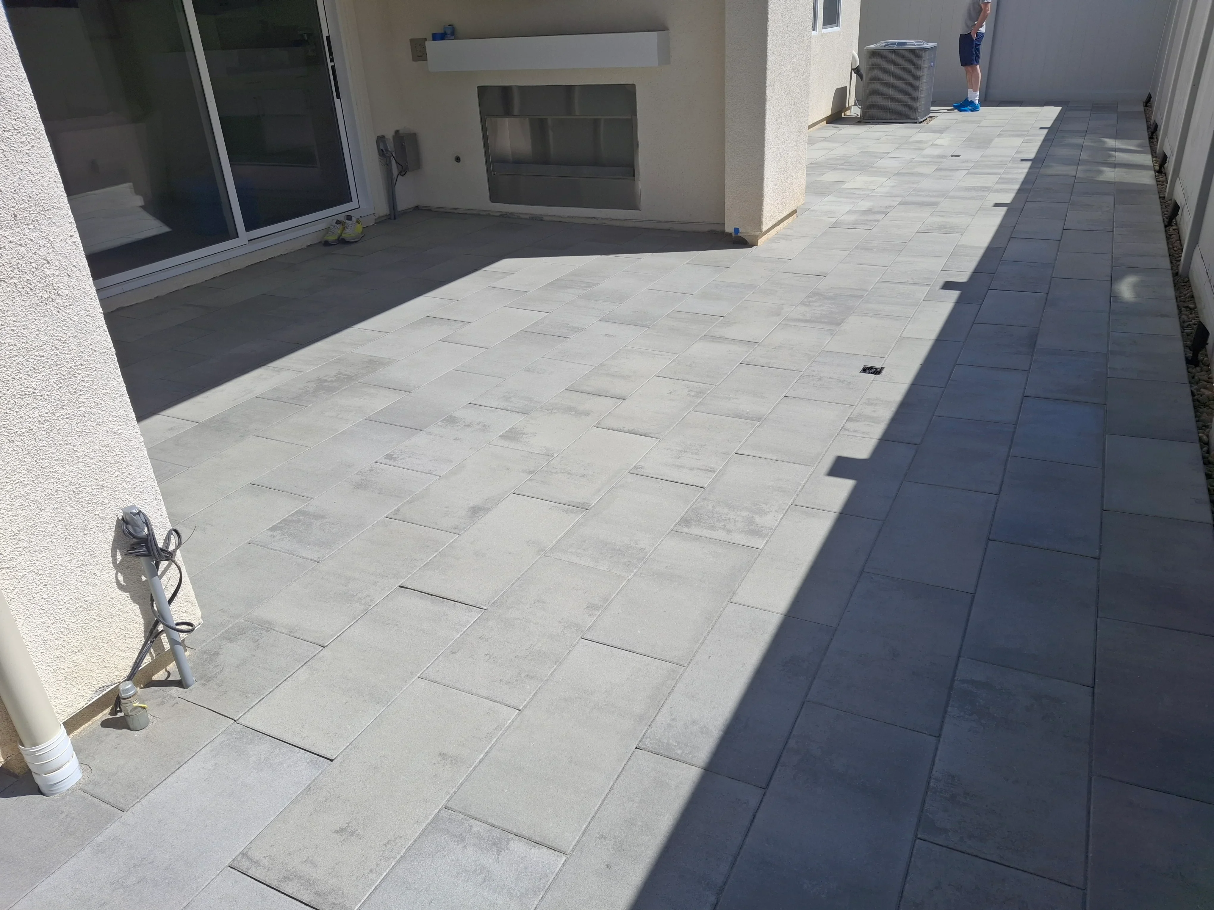 Light gray and charcoal concrete pavers in running bond pattern on residential patio