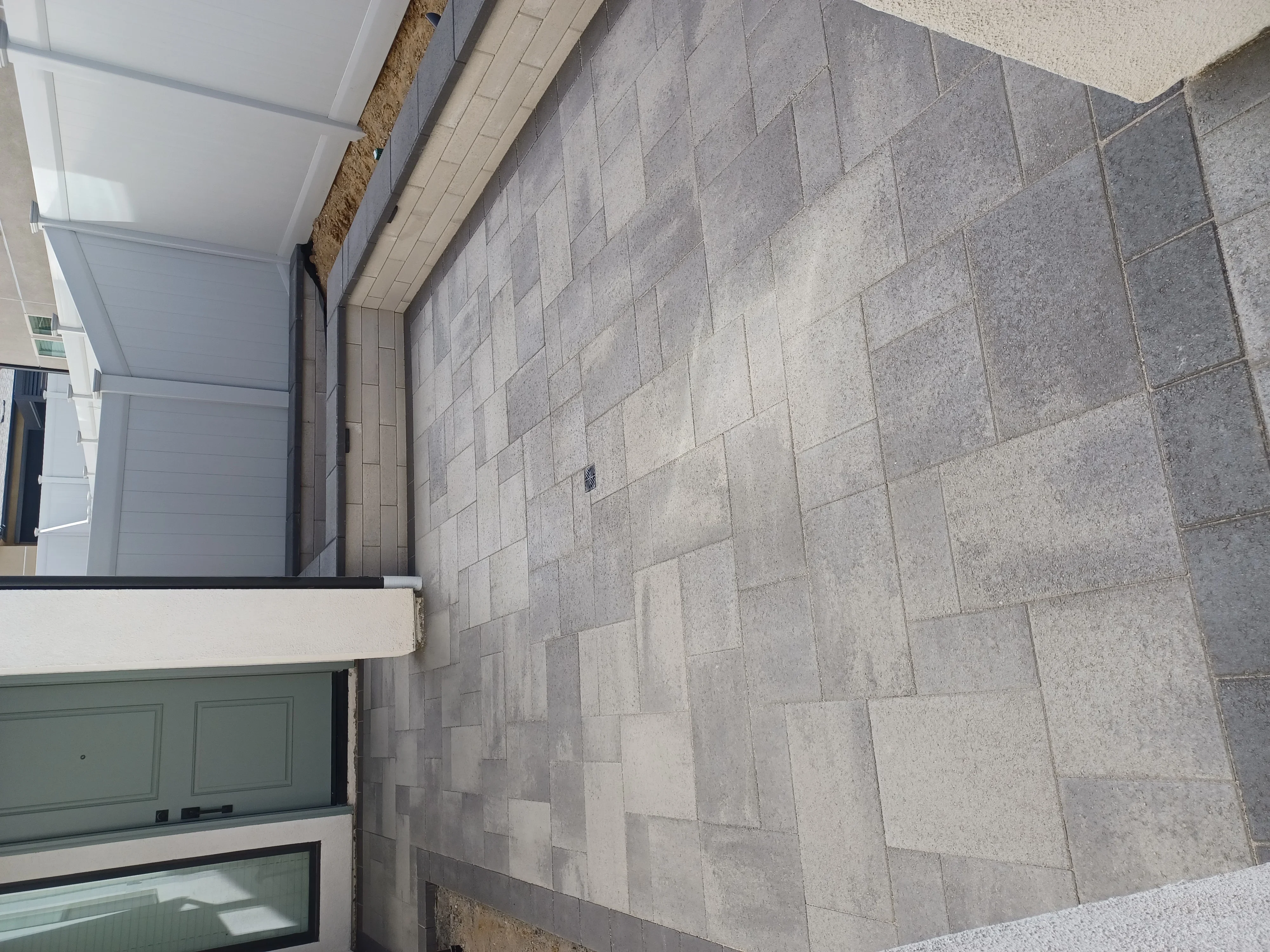 Gray concrete pavers in running bond pattern on residential patio
