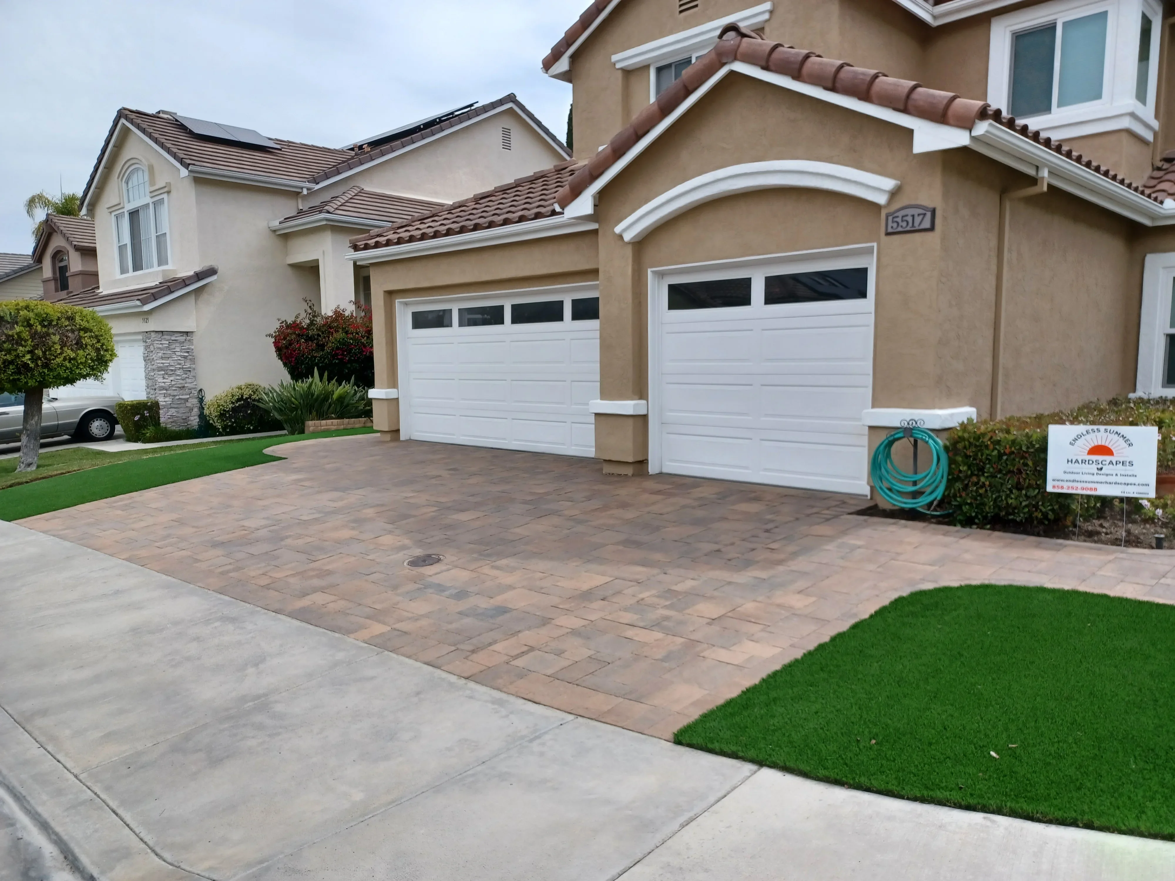Permeable clay paver driveway with running bond pattern and concrete approach apron