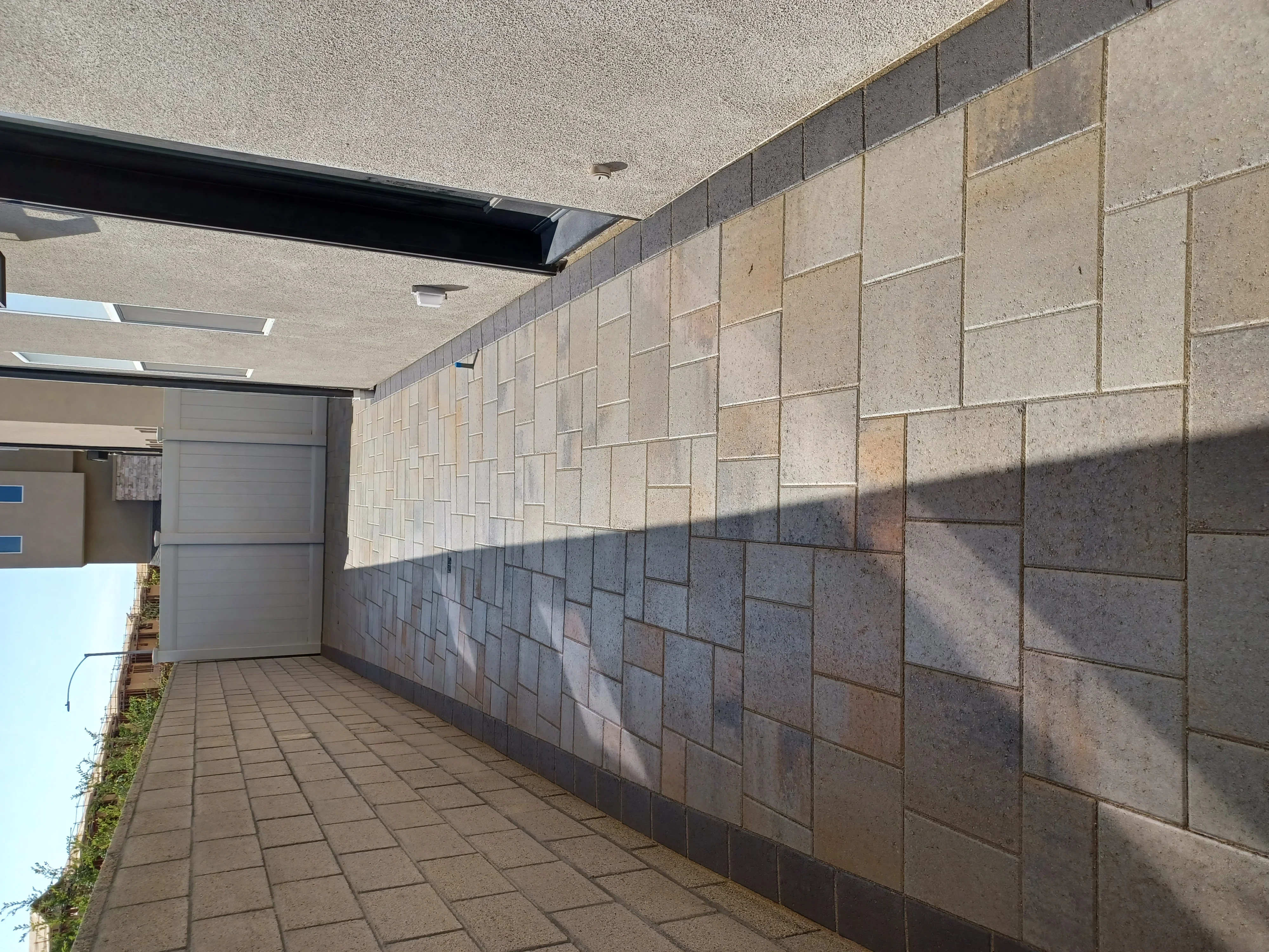 Concrete paver driveway and segmental retaining wall with stacked concrete blocks