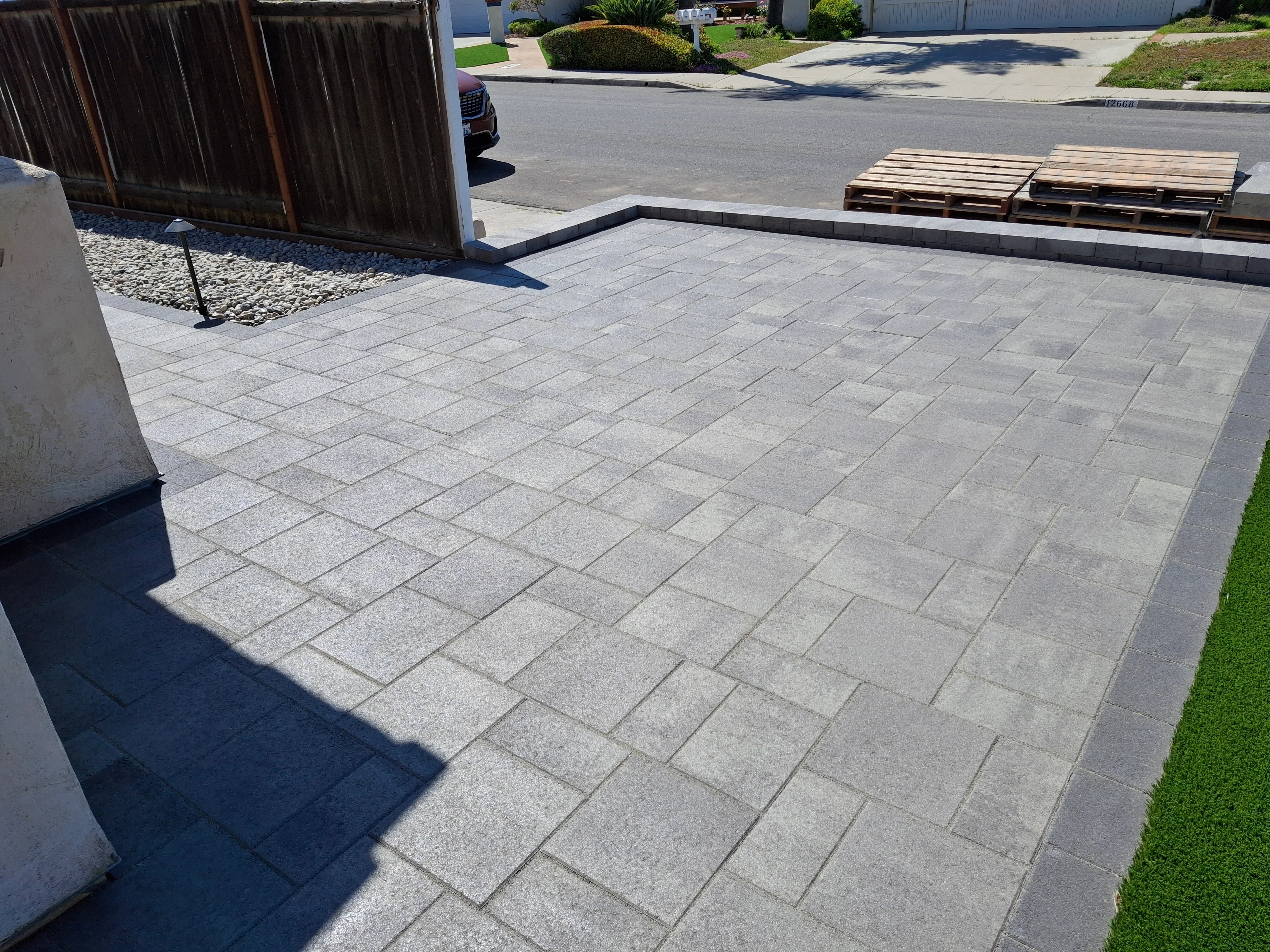 Light gray permeable pavers in running bond pattern with dark border edge detail