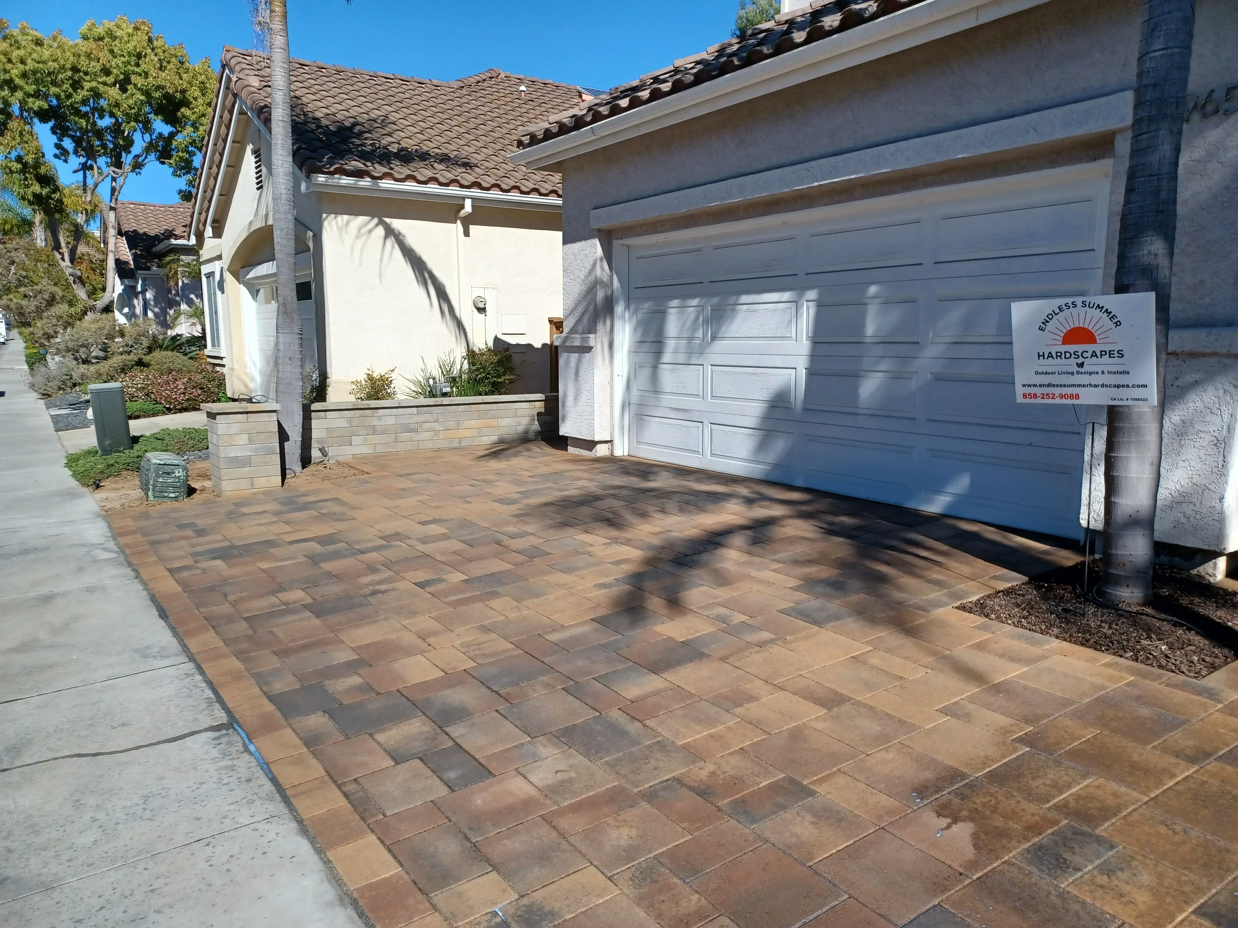 Clay brick permeable pavers in running bond pattern on residential driveway